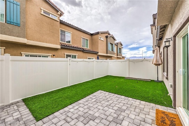 view of yard featuring a patio area and a fenced backyard