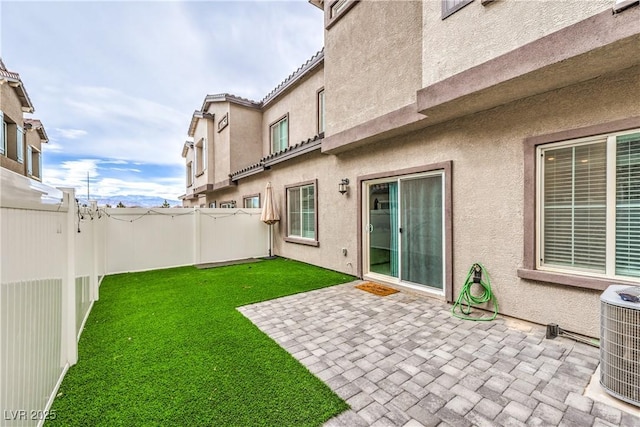 view of yard featuring a patio area, a fenced backyard, and central air condition unit