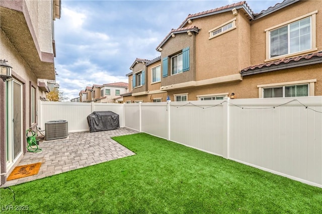 view of yard with a patio area, a fenced backyard, and cooling unit