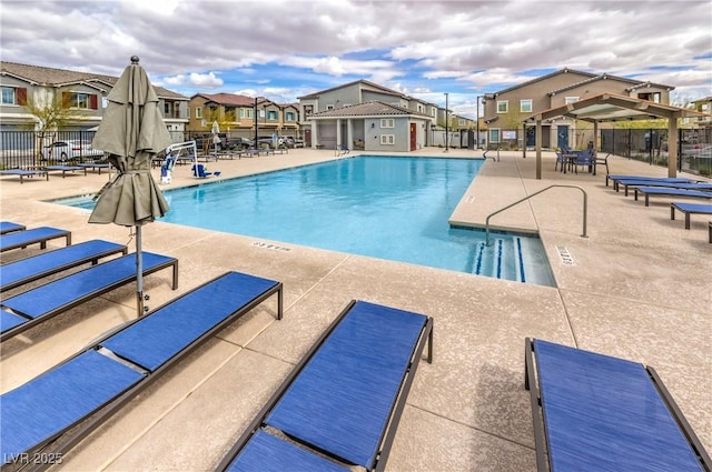 pool featuring a residential view, fence, and a patio