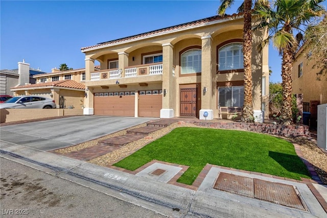 mediterranean / spanish-style house featuring an attached garage, driveway, a front yard, and stucco siding