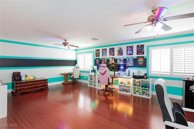 rec room featuring visible vents, ornamental molding, ceiling fan, wood finished floors, and baseboards