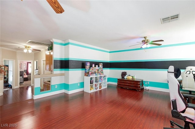 playroom with visible vents, dark wood finished floors, and ornamental molding