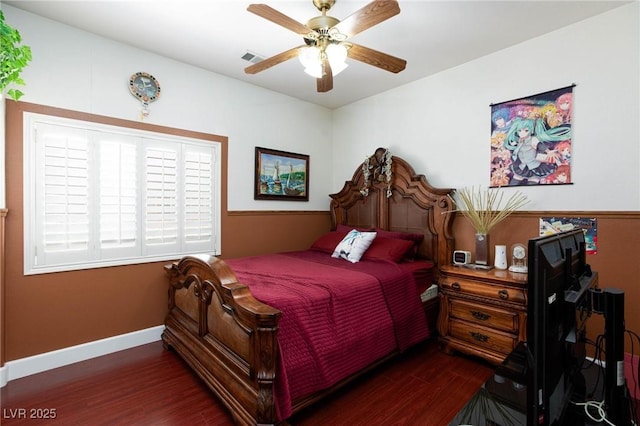 bedroom featuring dark wood-style floors, a ceiling fan, and baseboards