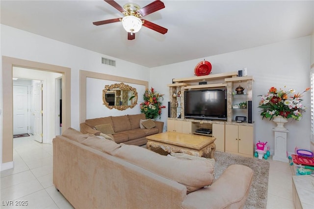 living room featuring light tile patterned floors, visible vents, and a ceiling fan