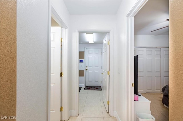 corridor with light tile patterned floors