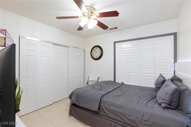 bedroom featuring ceiling fan, light tile patterned flooring, and visible vents