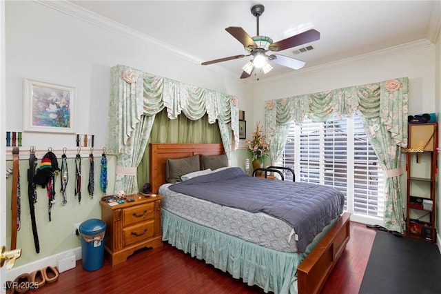 bedroom with ceiling fan, ornamental molding, dark wood finished floors, and visible vents