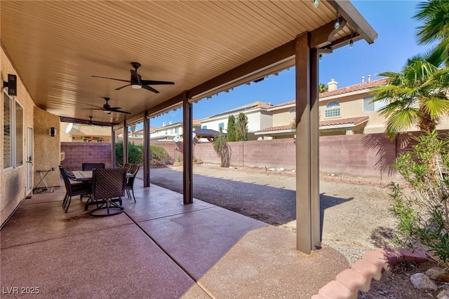 view of patio featuring outdoor dining area, a fenced backyard, and ceiling fan