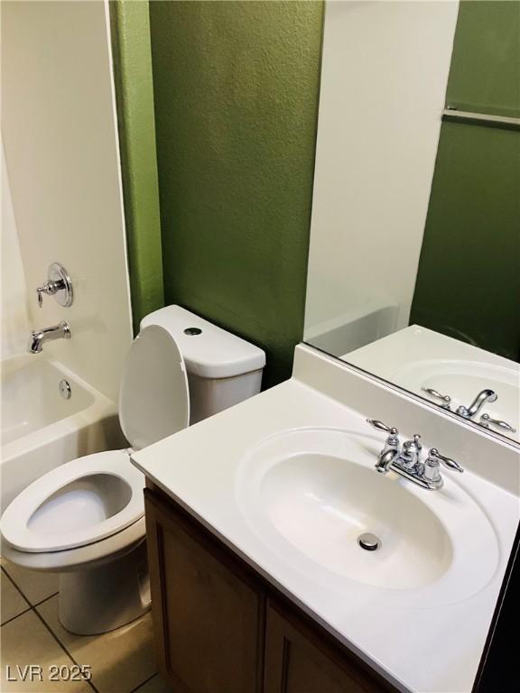 full bath with toilet, tile patterned flooring, vanity, and bathing tub / shower combination