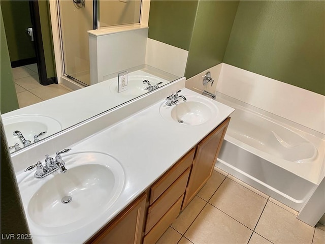 bathroom with a garden tub, a sink, and tile patterned floors