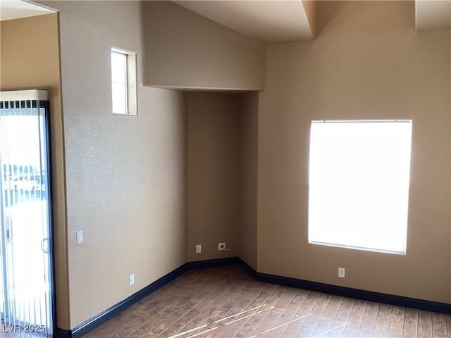 empty room featuring baseboards and wood finished floors