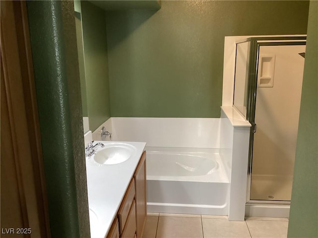 bathroom with a stall shower, vanity, a bath, and tile patterned floors