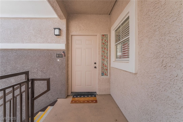 view of exterior entry featuring stucco siding