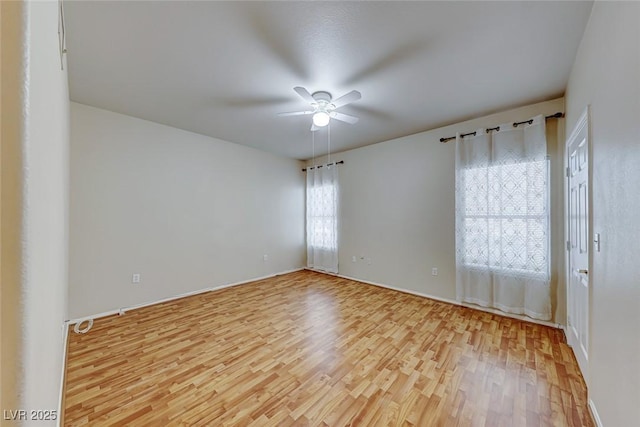 empty room featuring light wood-type flooring and a ceiling fan