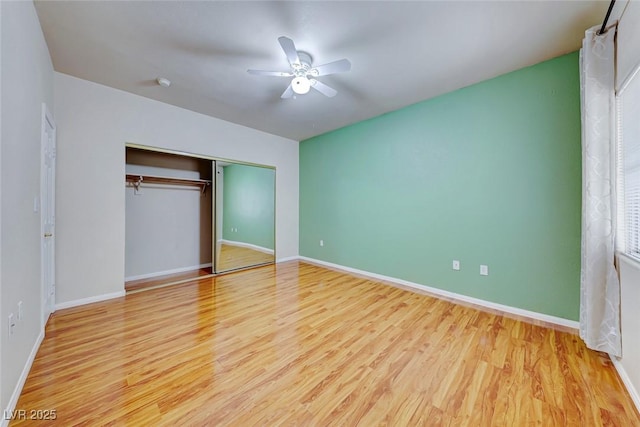 unfurnished bedroom featuring light wood finished floors, a closet, a ceiling fan, and baseboards