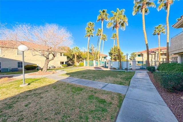 view of home's community featuring a residential view, fence, and a lawn