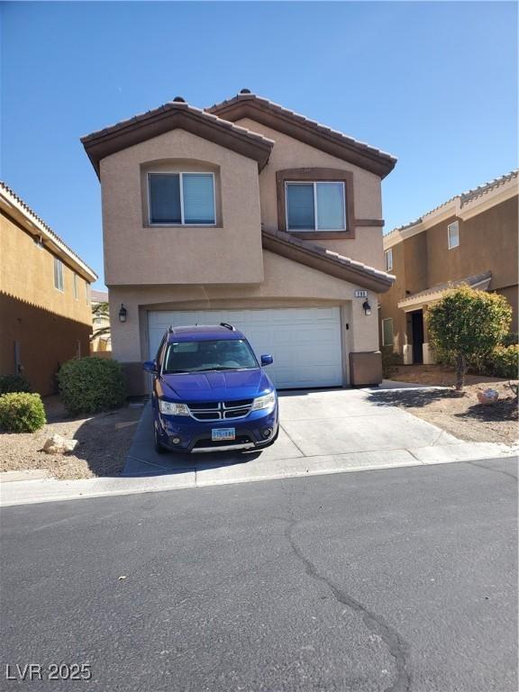 view of front of house featuring a garage, driveway, a tiled roof, and stucco siding