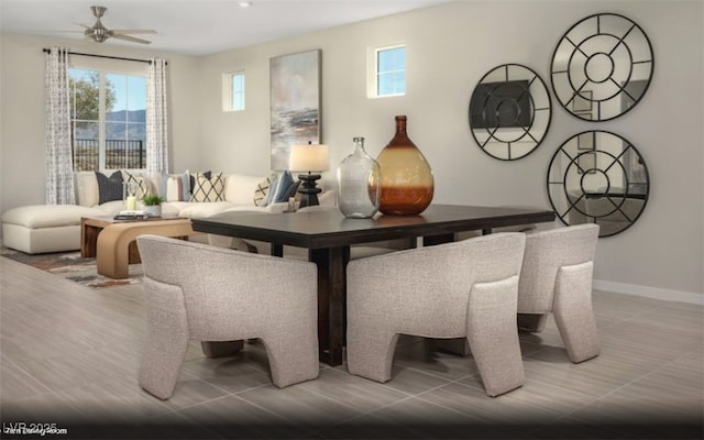 dining area with ceiling fan and baseboards