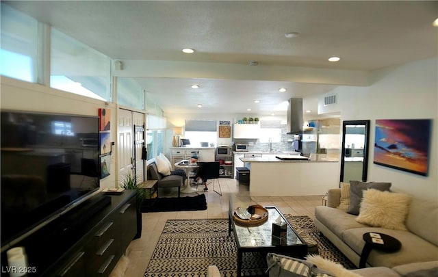 living room featuring recessed lighting, visible vents, and vaulted ceiling