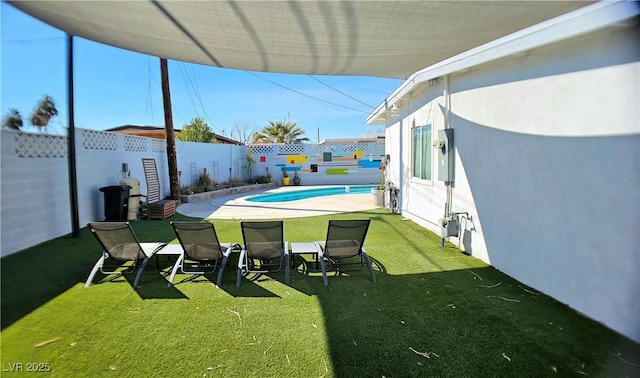 view of pool with a patio area, a fenced backyard, a lawn, and a fenced in pool