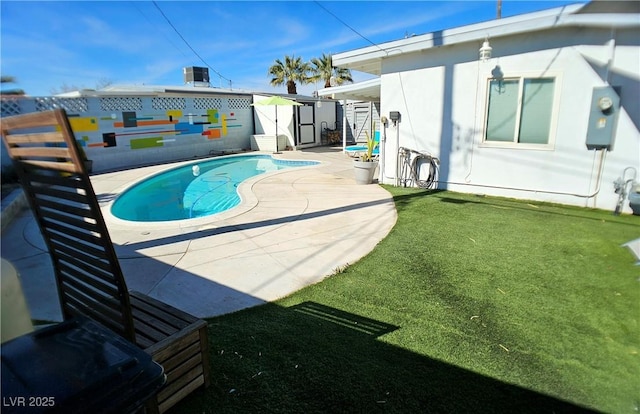 view of swimming pool with a fenced in pool, a yard, a patio, central AC, and an outdoor structure