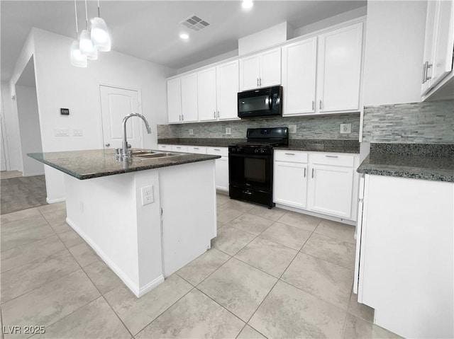 kitchen featuring visible vents, a kitchen island with sink, a sink, white cabinetry, and black appliances