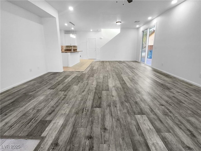 unfurnished living room with baseboards, dark wood-style flooring, a ceiling fan, and recessed lighting