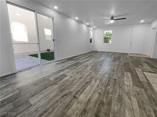 spare room with recessed lighting, ceiling fan, baseboards, and wood finished floors