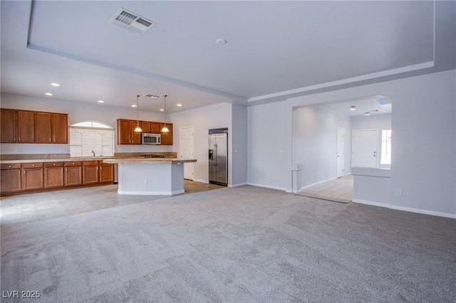 unfurnished living room with recessed lighting, baseboards, visible vents, and light colored carpet