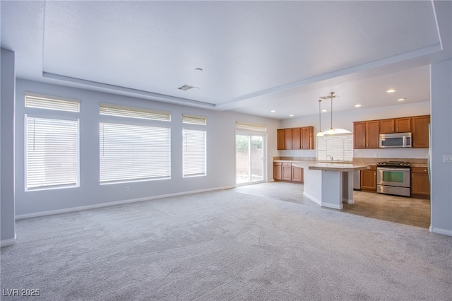 unfurnished living room featuring baseboards, recessed lighting, visible vents, and light colored carpet