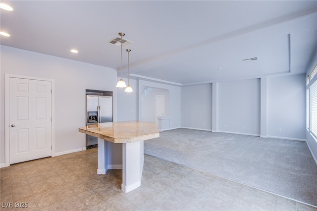 kitchen featuring visible vents, a kitchen breakfast bar, light countertops, hanging light fixtures, and stainless steel fridge with ice dispenser