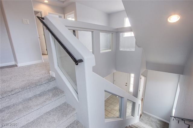 stairs with carpet floors and baseboards