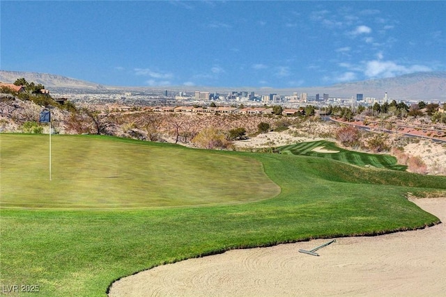 view of home's community featuring a view of city, golf course view, and a mountain view