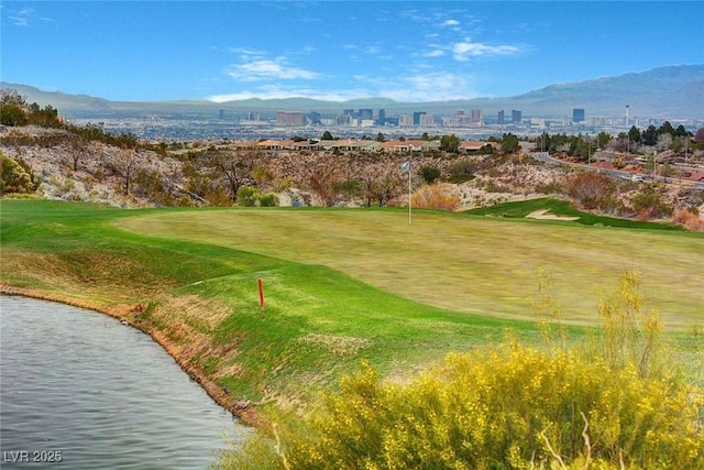 view of property's community featuring golf course view, a water and mountain view, and a city view