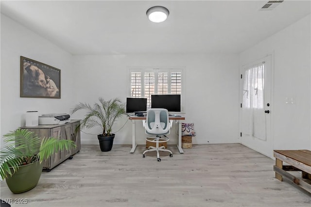 home office featuring light wood-style floors and visible vents