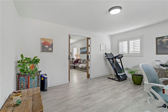 office area featuring light wood finished floors and baseboards