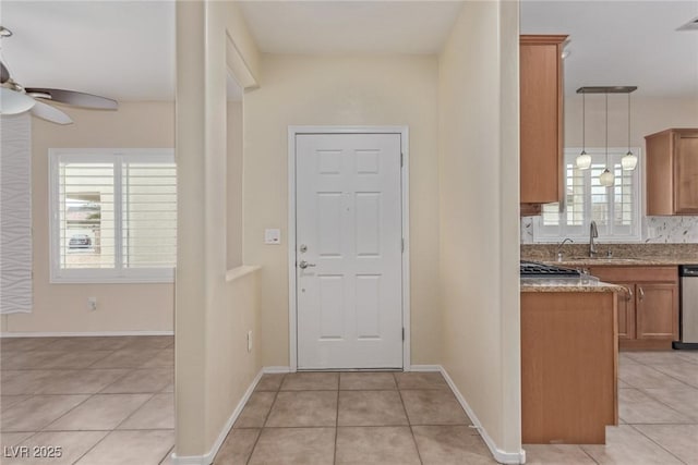 interior space with light tile patterned floors, visible vents, baseboards, and ceiling fan