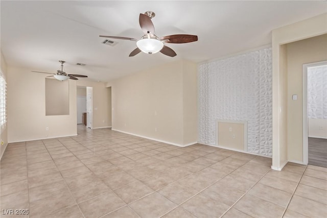 unfurnished room with light tile patterned floors, visible vents, baseboards, and a ceiling fan