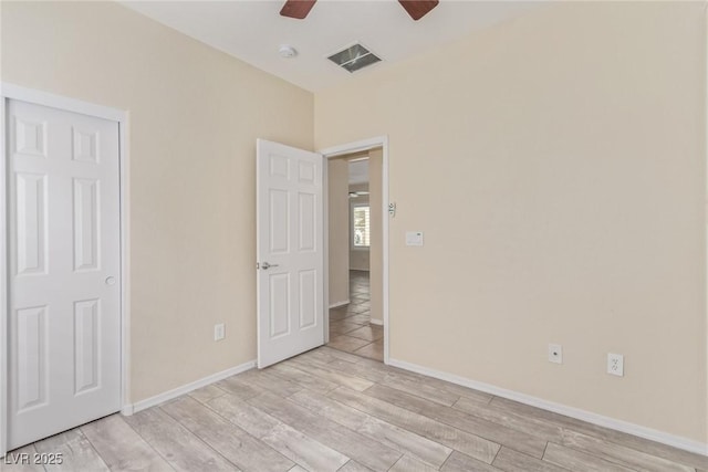 unfurnished bedroom with visible vents, baseboards, light wood-style floors, and ceiling fan