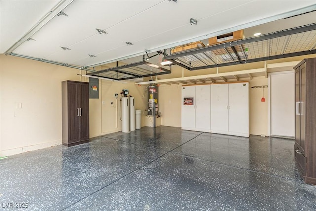 garage featuring water heater, gas water heater, a garage door opener, and electric panel