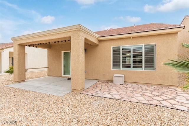 back of property featuring stucco siding and a patio