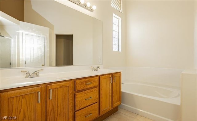 full bathroom with tile patterned flooring, double vanity, a sink, and a bath