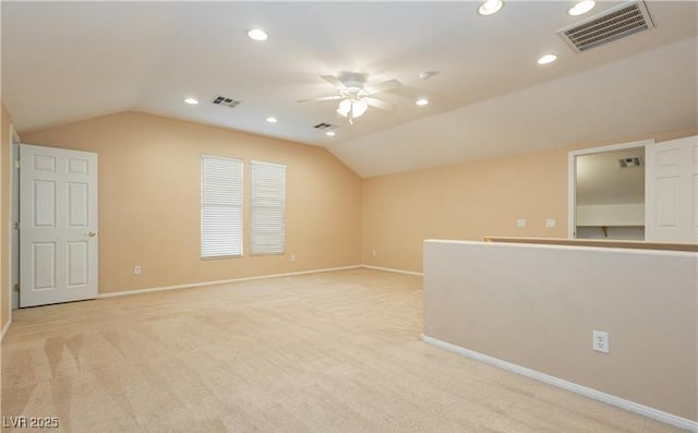 additional living space with light colored carpet, lofted ceiling, visible vents, and recessed lighting