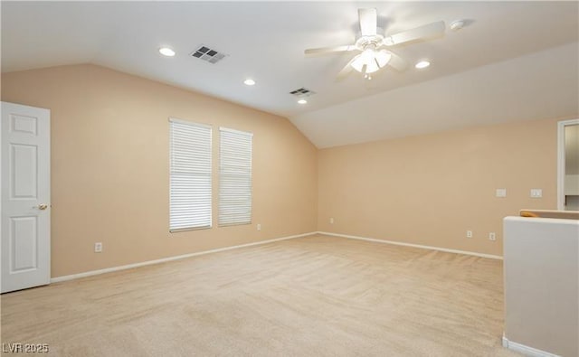 interior space featuring vaulted ceiling, light carpet, and visible vents