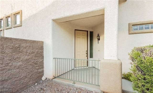 entrance to property featuring stucco siding