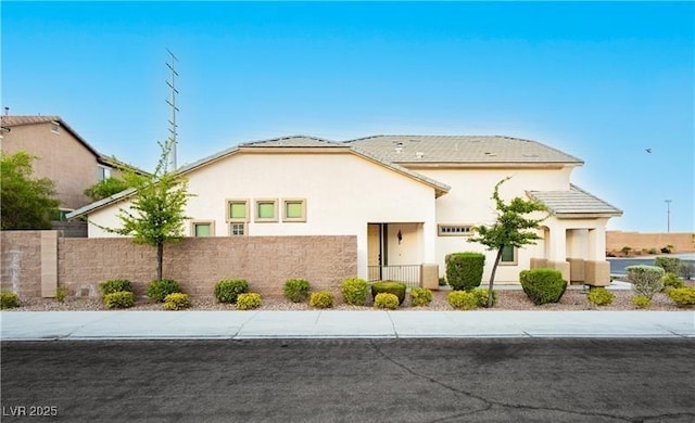 view of front of house featuring a fenced front yard and stucco siding