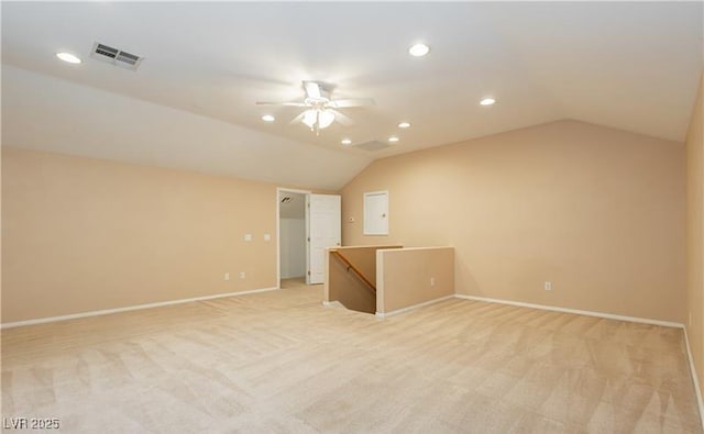 empty room with lofted ceiling, visible vents, and light colored carpet