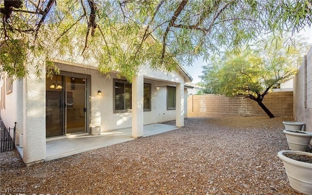 exterior space with a patio area and a fenced backyard