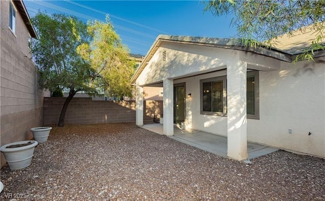 view of home's exterior featuring a fenced backyard, a patio, and stucco siding